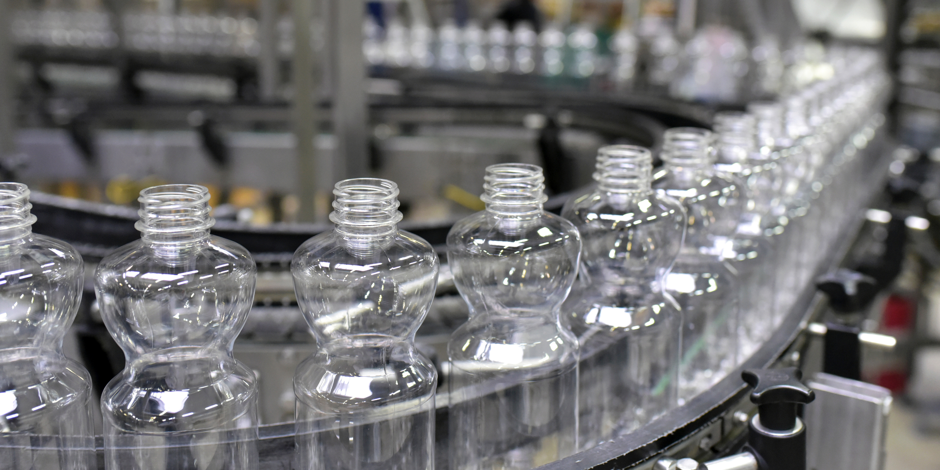 Close-up of plastic bottles on assembly line.