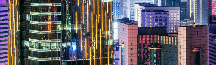 Medium angle of skyscrapers in city at night.