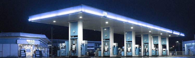Wide angle of gas station at night.