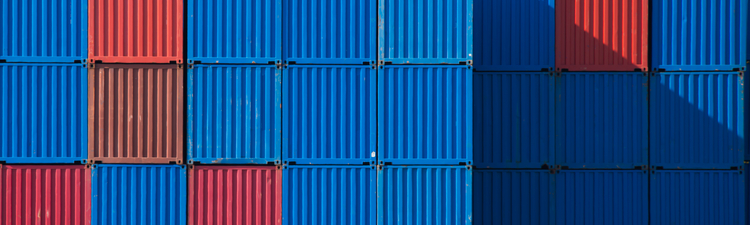 Stacks of shipping containers in a row