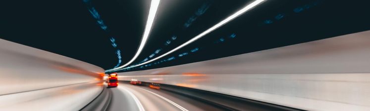 Wide angle blurred motion of bus inside tunnel.