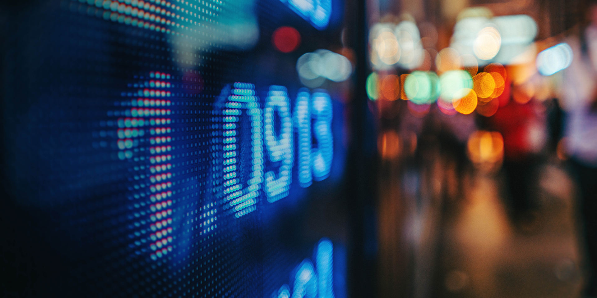 display stock market numbers with defocused street lights background 