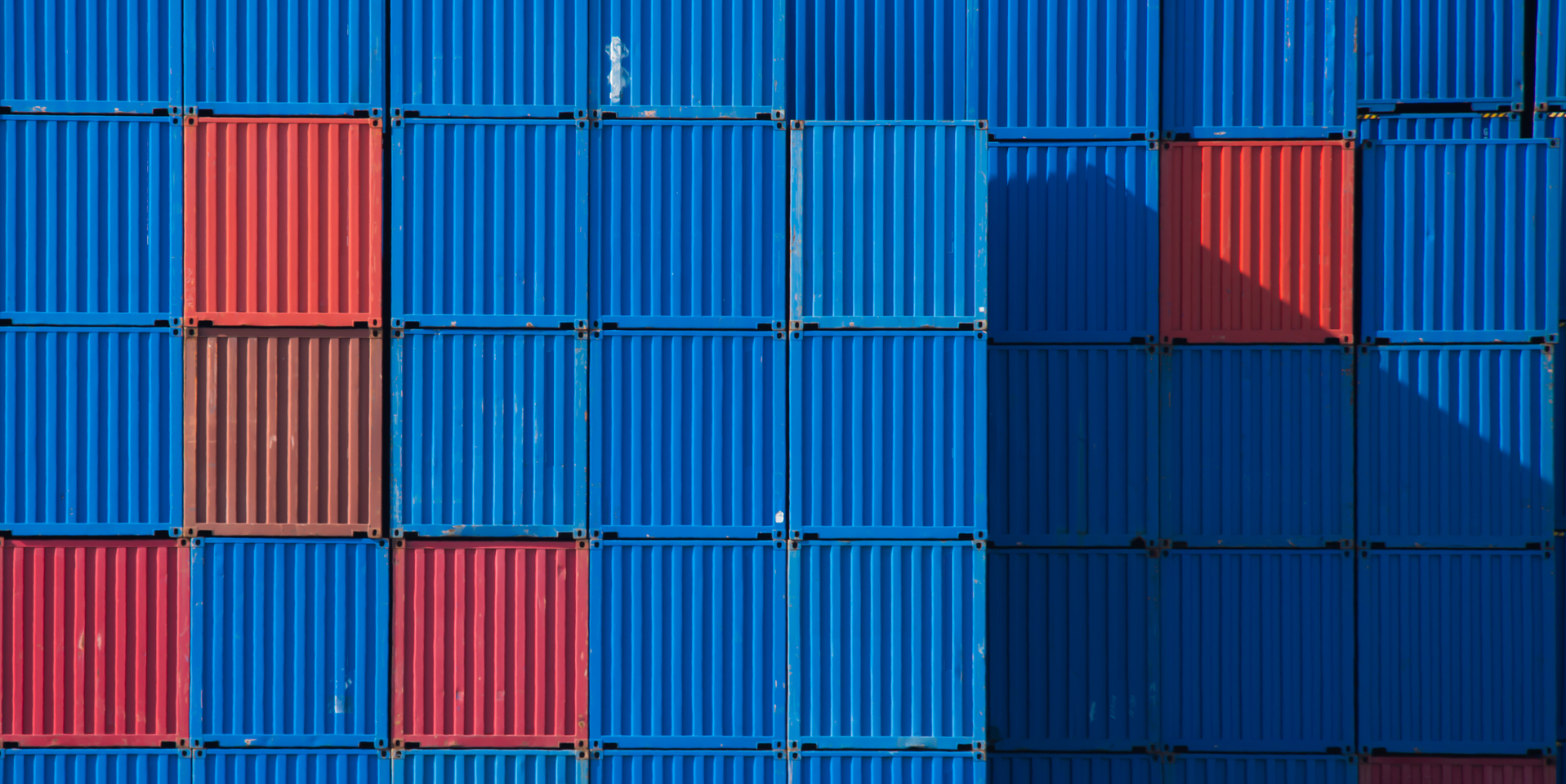 Stacks of shipping containers in a row