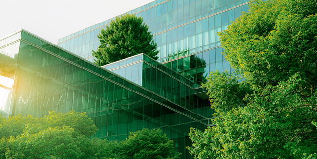 Sustainble green building. Eco-friendly building. Sustainable glass office building with tree for reducing carbon dioxide. Office with green environment. Corporate building reduce CO2. Safety glass.