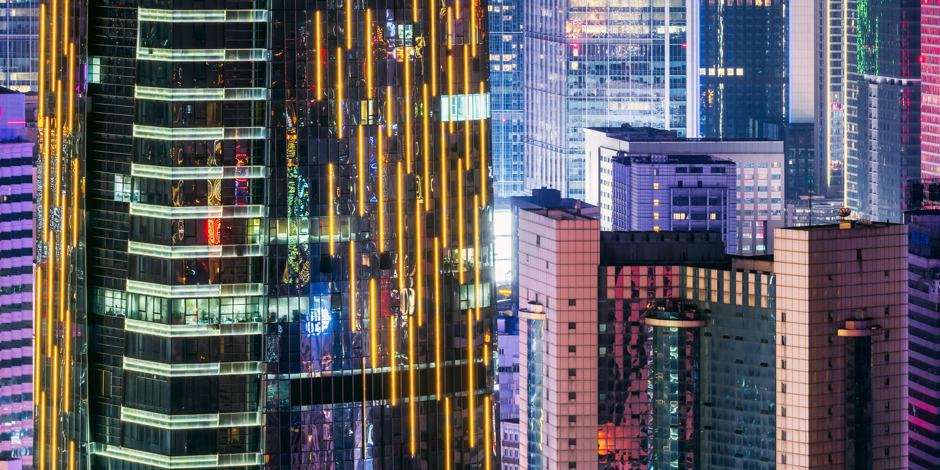 Medium angle of skyscrapers in city at night.