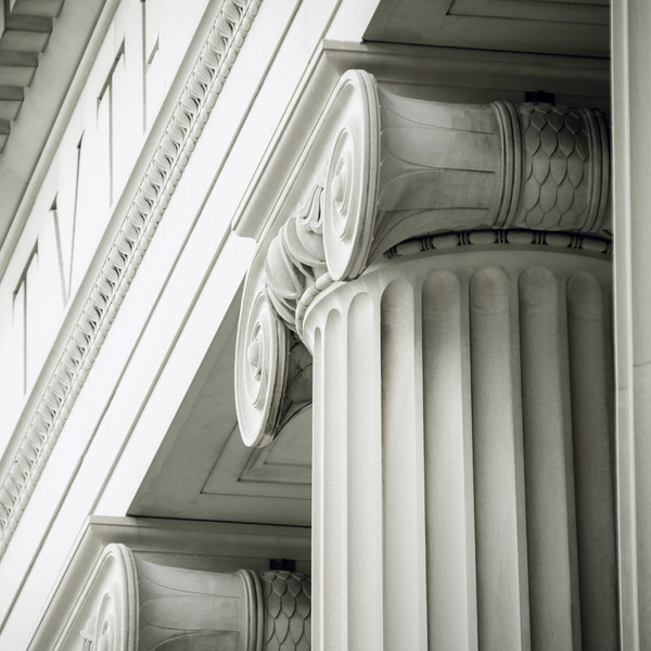Close-up on Ionic columns of a courthouse.