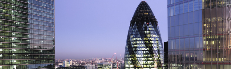 UK, London, looking East from above with view of high rise office towers illuminated at twilight