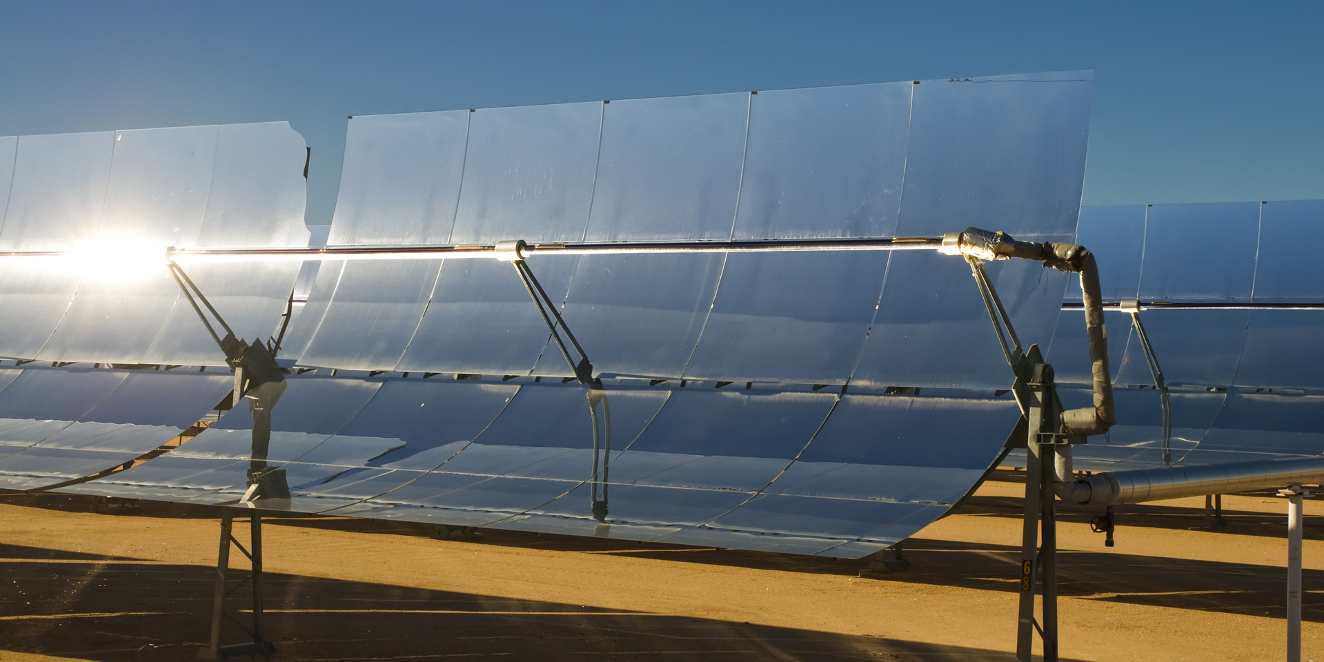 SEGS solar thermal energy electricity plant with parabolic mirrors concentrating the sunlight