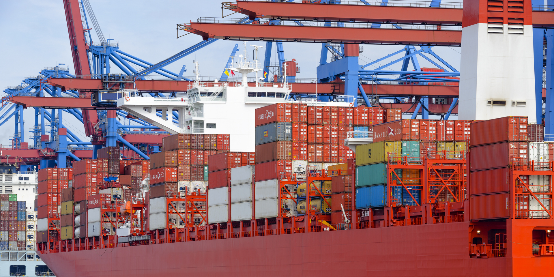 Cargo ship with shipping containers docked at the container terminal in the port of Hamburg.
