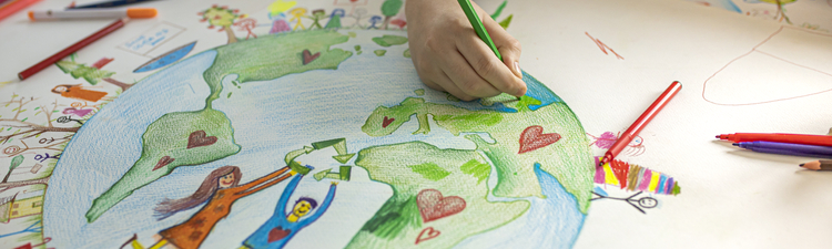 Close up of child's hands while drawing Ecofriendly theme on paper.