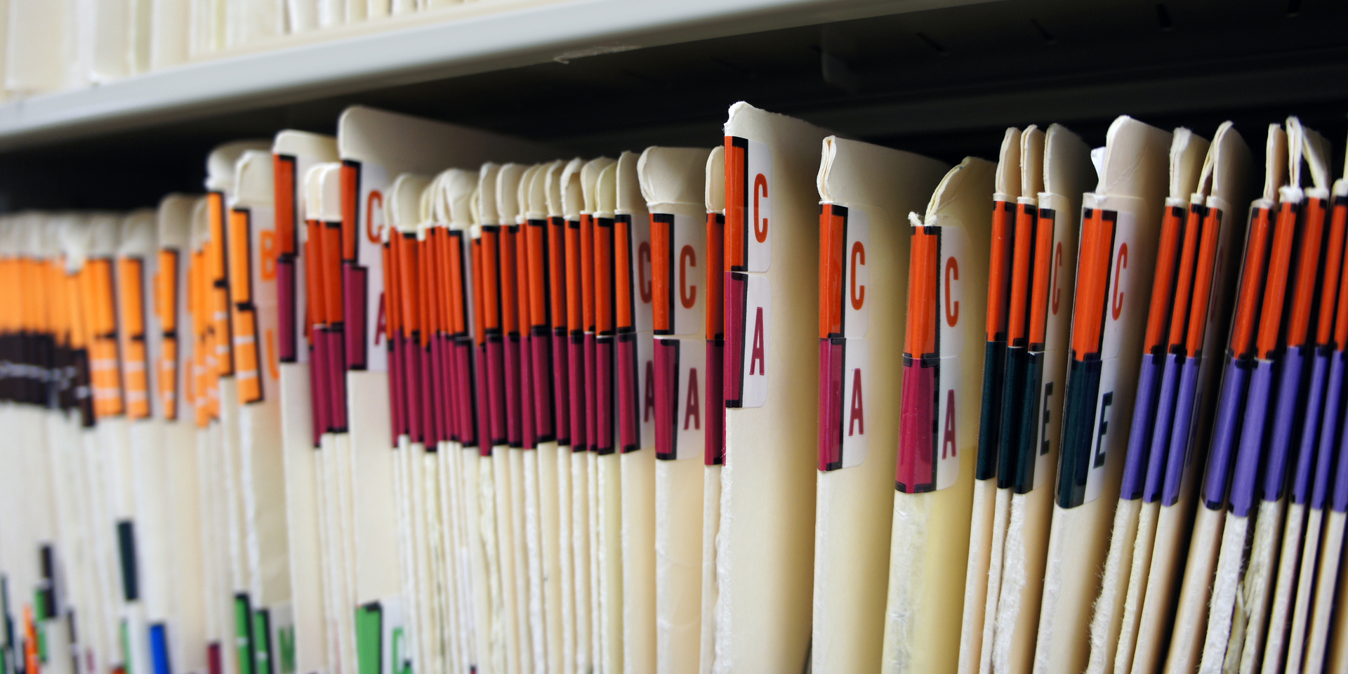Close-up of medical records in file room at doctor's office.