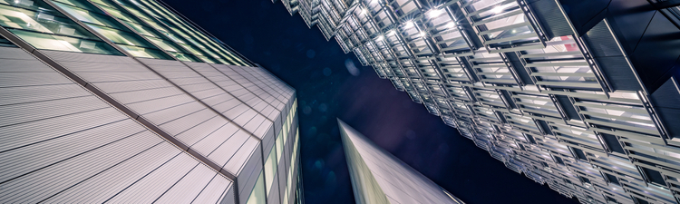 Highly detailed abstract wide angle view up towards the sky in the financial district of London City and its ultra modern contemporary buildings with unique contemporary architecture during night time. Shot on Canon EOS R full frame with 14mm wide angle prime lens. Image is ideal for background with copy space and no people.