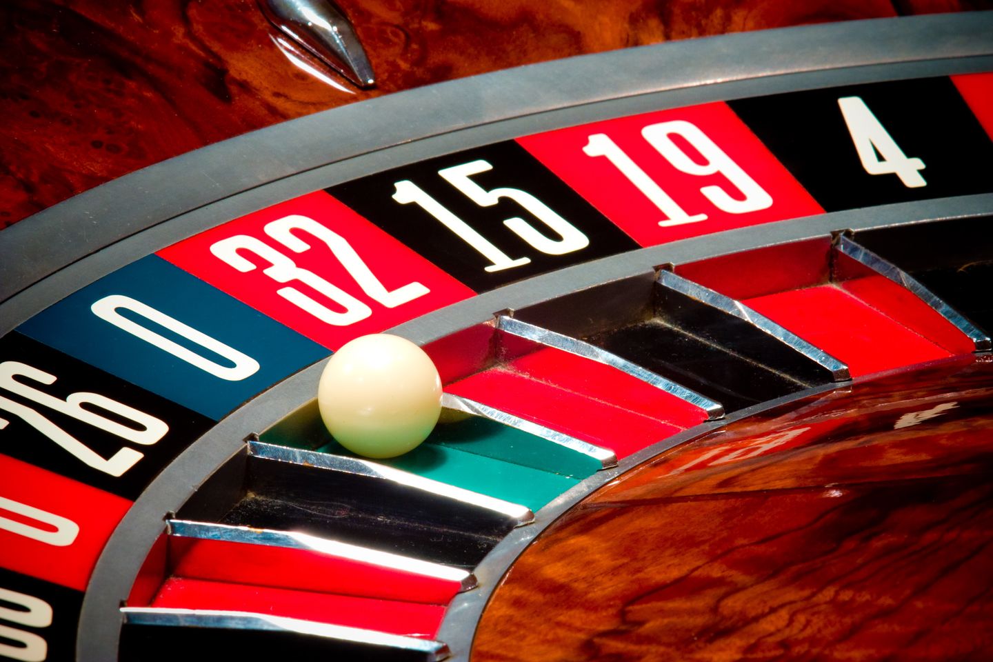 Close-up of roulette ball and wheel in casino.